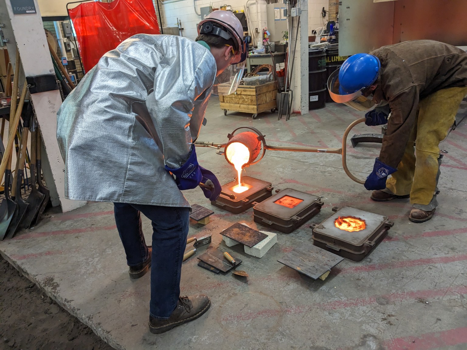 Colorado School of Mines team members pouring regolith slag into tile sandcasting molds to review applicability for use as building products in the 2023 BIG Idea Challenge.