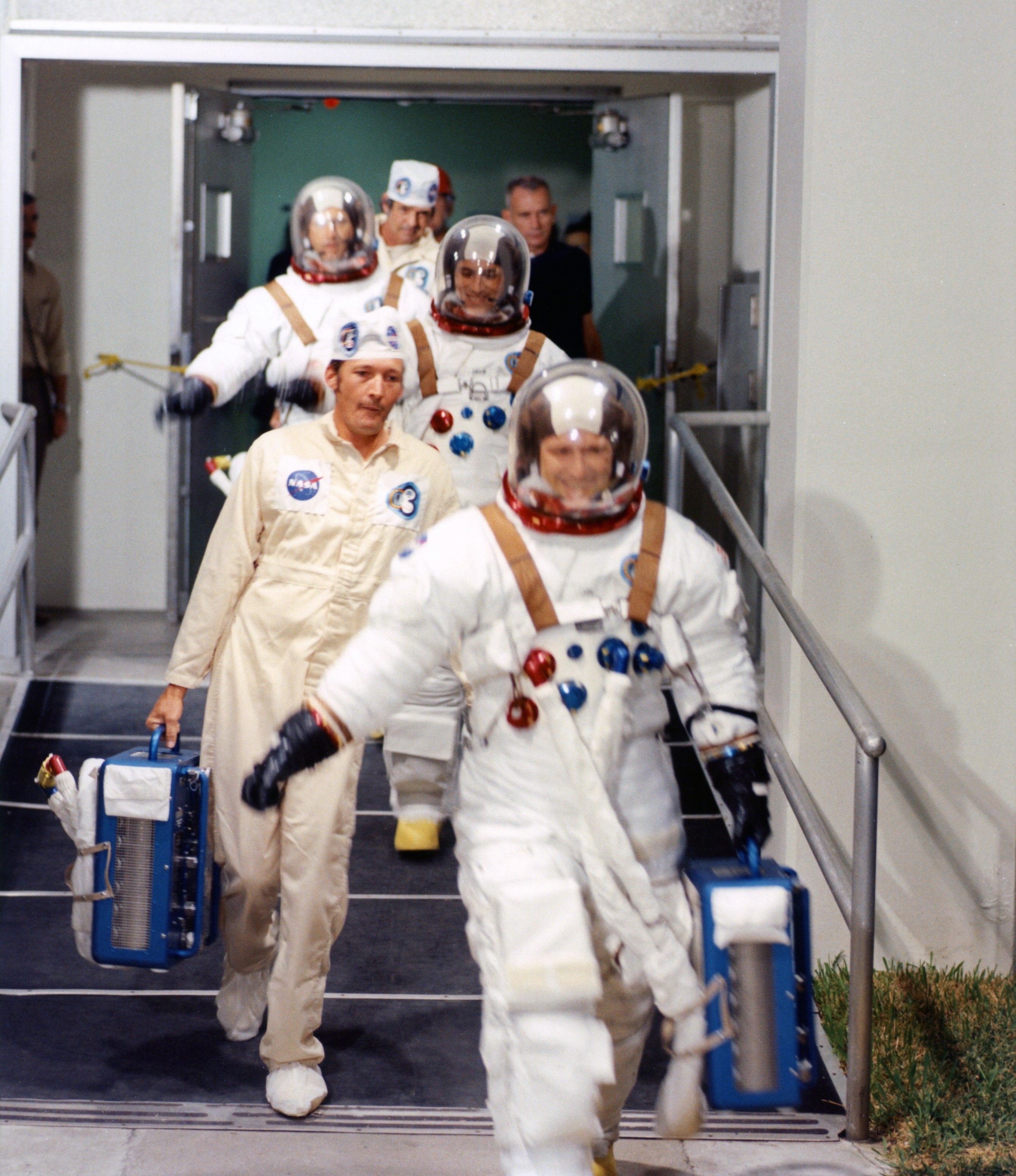 Breaking News Picture of Carr, entrance, Gibson, and Pogue exit crew quarters to board the switch van for the hurry to Initiate Pad 39B