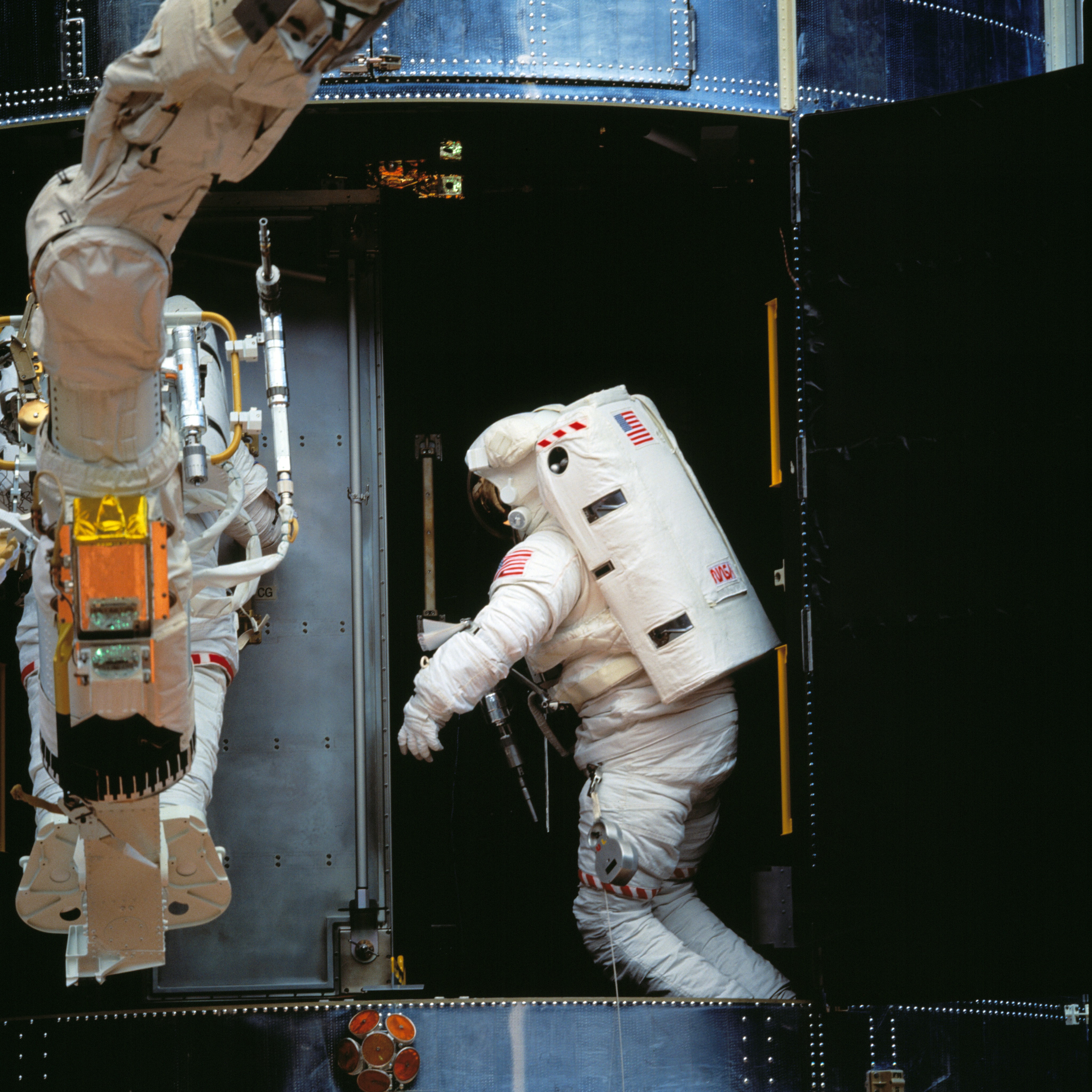 Astronaut Thomas D. Akers, inside the Hubble Space Telescope prepares to install the COSTAR
