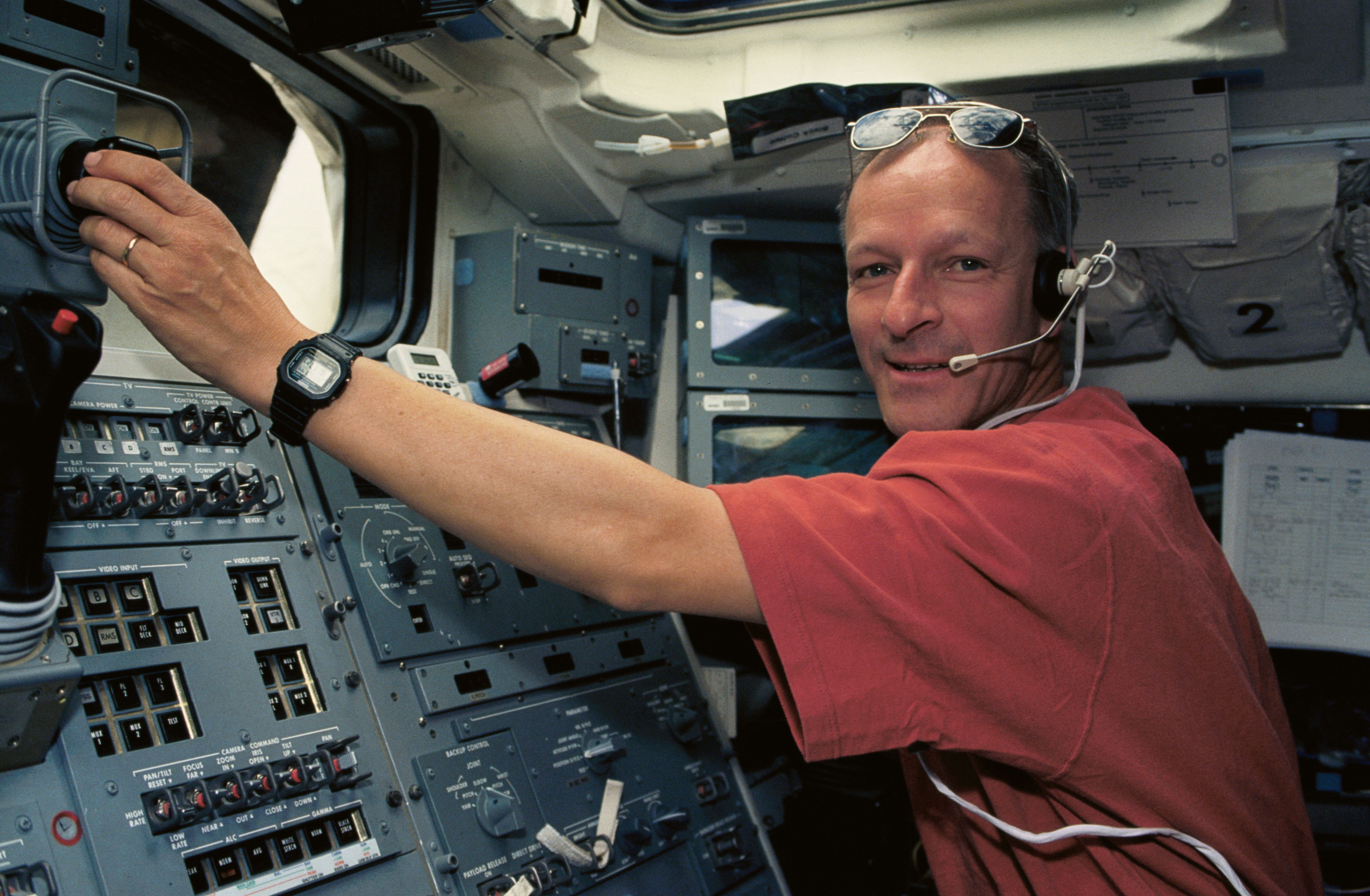 On the shuttle’s flight deck, European Space Agency astronaut Claude Nicollier operates the RMS to grapple Hubble