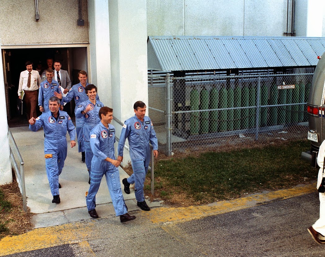 On launch day at NASA’s Kennedy Space Center in Florida, the STS-9 astronauts leave crew quarters to board the Astrovan for the ride to Launch Pad 39A