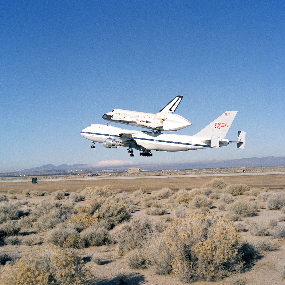 Atop a Shuttle Carrier Aircraft, Columbia begins its cross country journey to NASA’s Kennedy Space Center in Florida