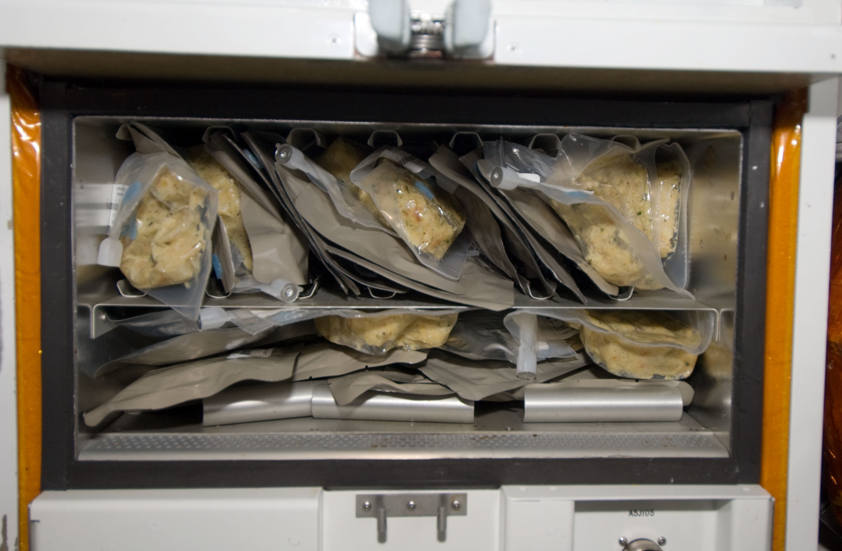 Photo of the Thanksgiving dinner reheating in space shuttle Endeavour’s food warmer