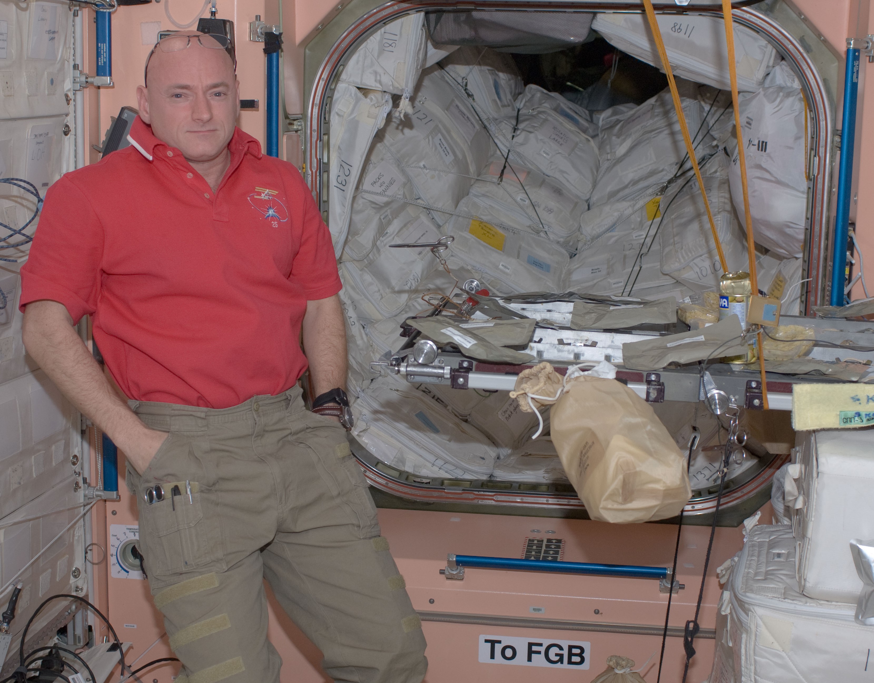 Expedition 25 commander and NASA astronaut Scott J. Kelly awaits his crewmates at the Thanksgiving dinner table