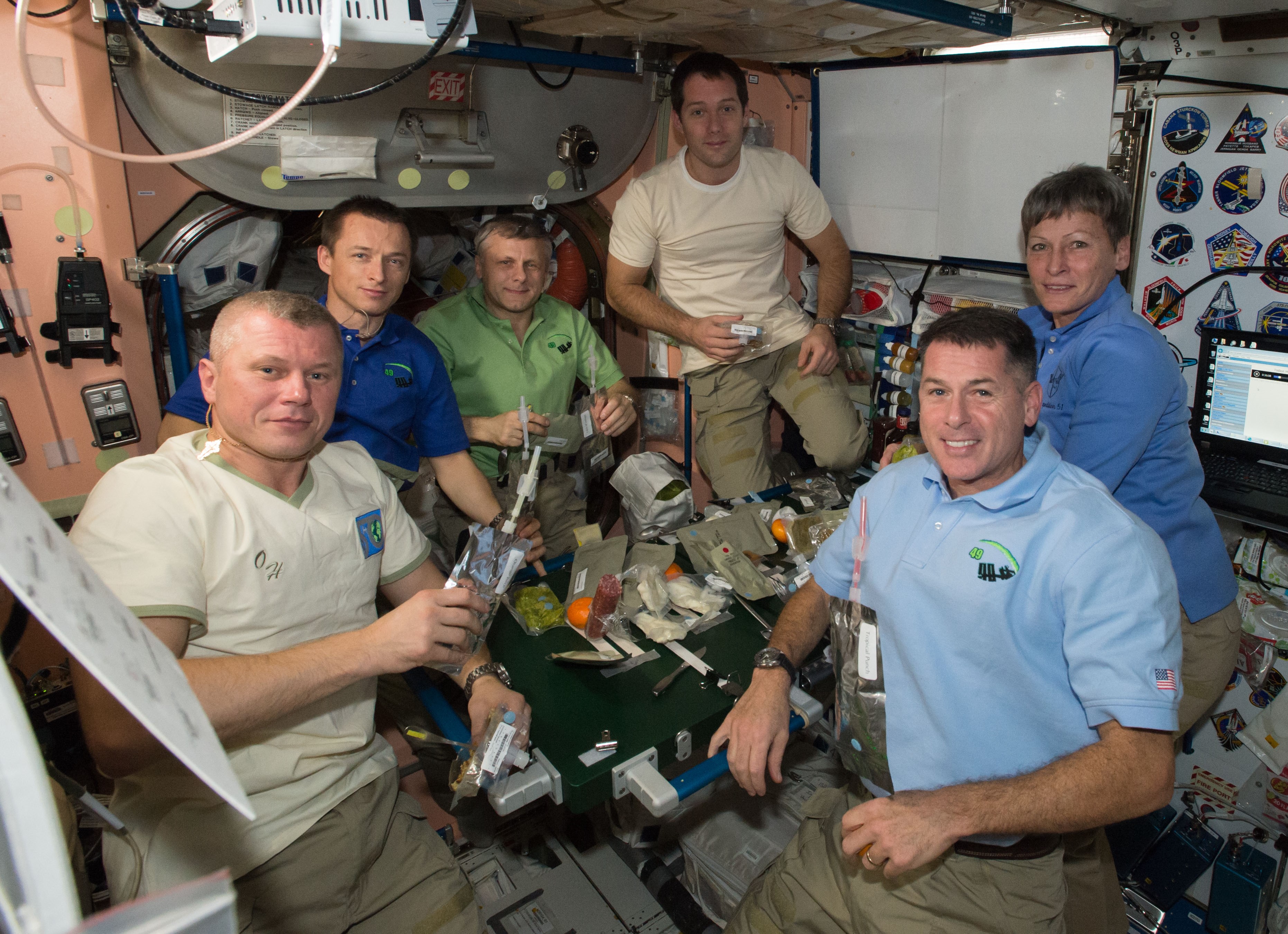 Expedition 50 crew members Oleg V. Novitsky, left, Sergei N. Ryzhikov, and Andrei I. Borisenko of Roscosmos, Thomas G. Pesquet of the European Space Agency, and NASA astronauts R. Shane Kimbrough and Peggy A. Whitson pose before the Thanksgiving dinner table