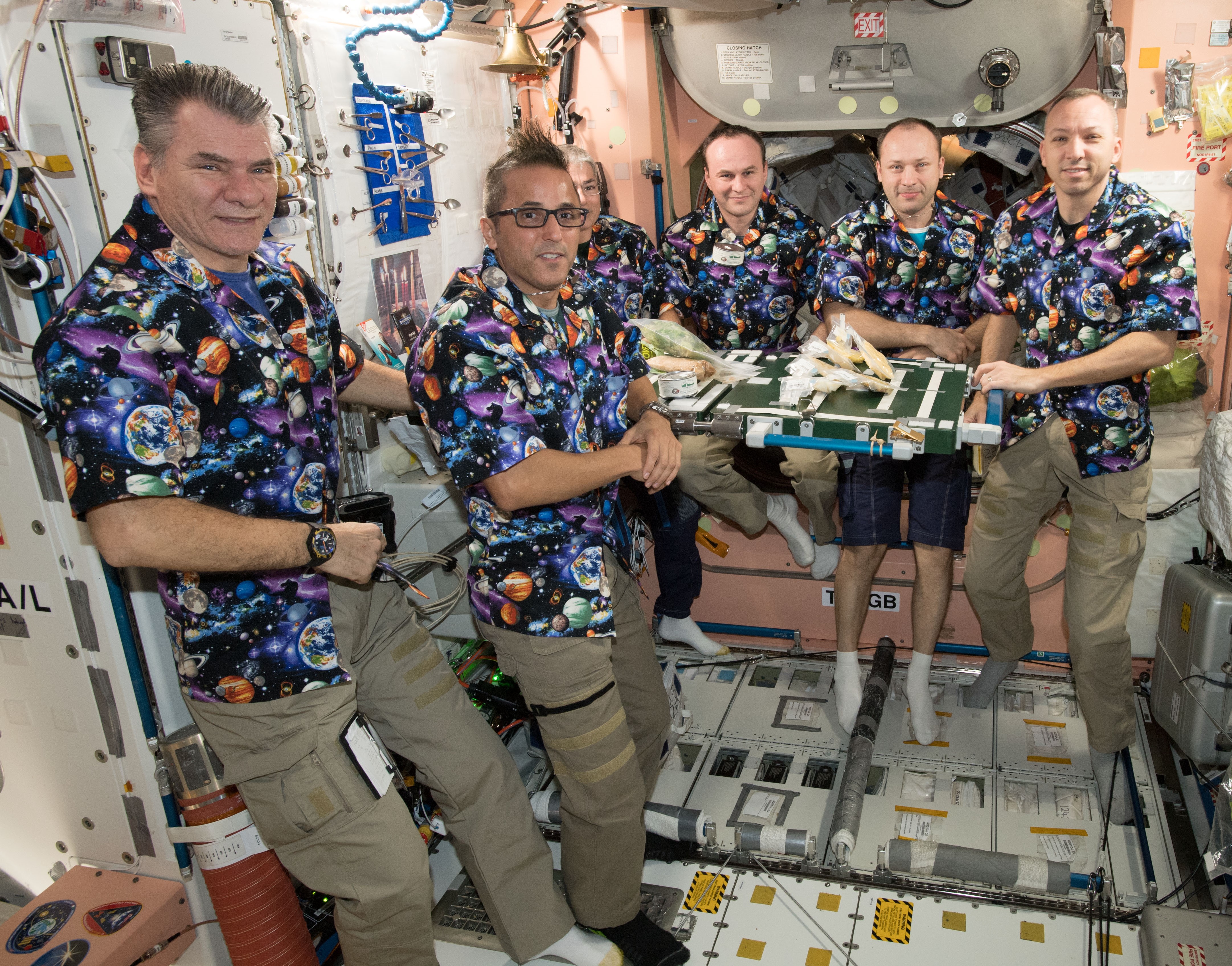 The Expedition 53 crew of Paolo A. Nespoli of the European Space Agency, left, NASA astronauts Joseph M. Acaba and Mark T. Vande Hei, Sergei N. Ryazansky and Aleksandr A. Misurkin of Roscosmos, and NASA astronaut Randolph J. Bresnik patiently awaits the start of the dinner