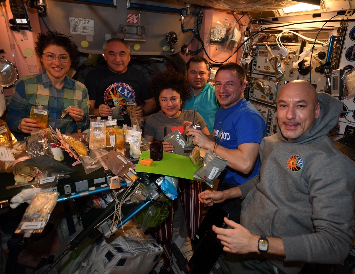 Expedition 61 crew members NASA astronaut Christina H. Koch, left, Aleksandr A. Skvortsov of Roscosmos, NASA astronaut Jessica U. Meir, Oleg I. Skripochka of Roscosmos, NASA astronaut Andrew R. Morgan, and Luca S. Parmitano of the European Space Agency celebrate Thanksgiving aboard the space station