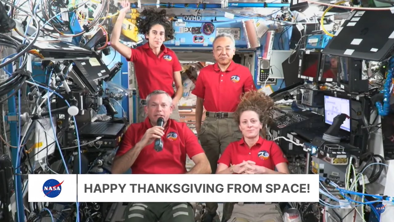 Expedition 70 crew members Andreas E. Mogensen, of the European Space Agency, front left, NASA astronauts Loral A. O’Hara and Jasmin Moghbeli, and Satoshi Furukawa of the Japan Aerospace Exploration Agency beam down their Thanksgiving message to everyone on the ground