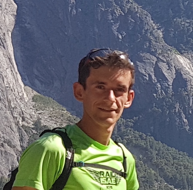 Photo of Valentin Le Gouellec hiking with rocks behind him.