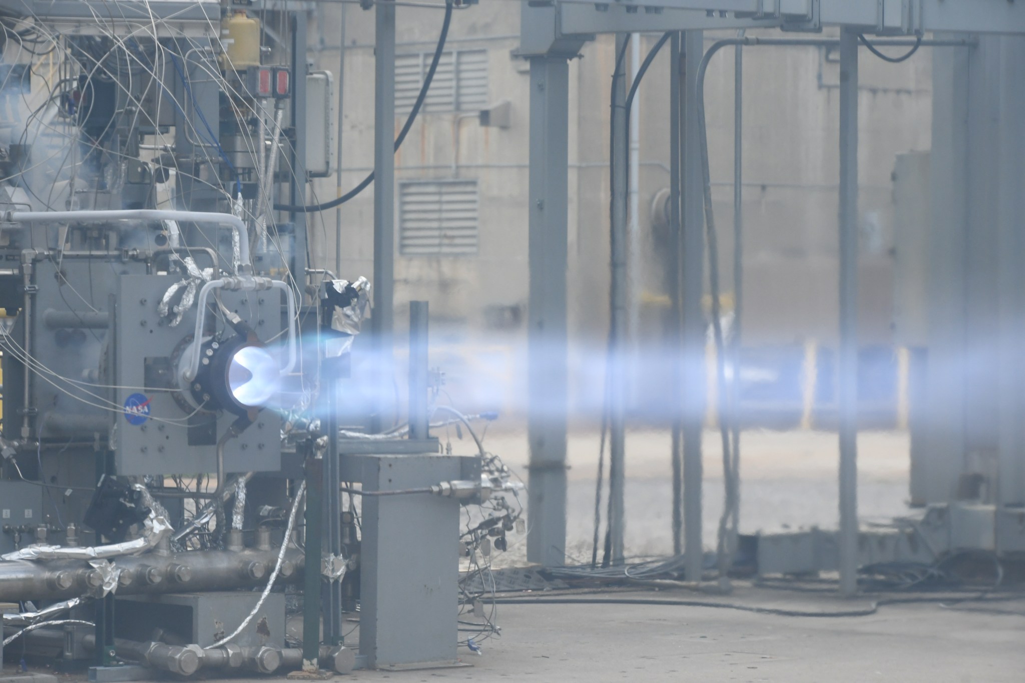 A stream of white-hot fire is coming out of Rotaging Detonation Rocket Engine combustor.