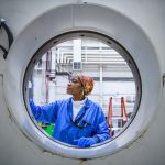 PACE tech Jean Arnett is cleaning the Aronson table.