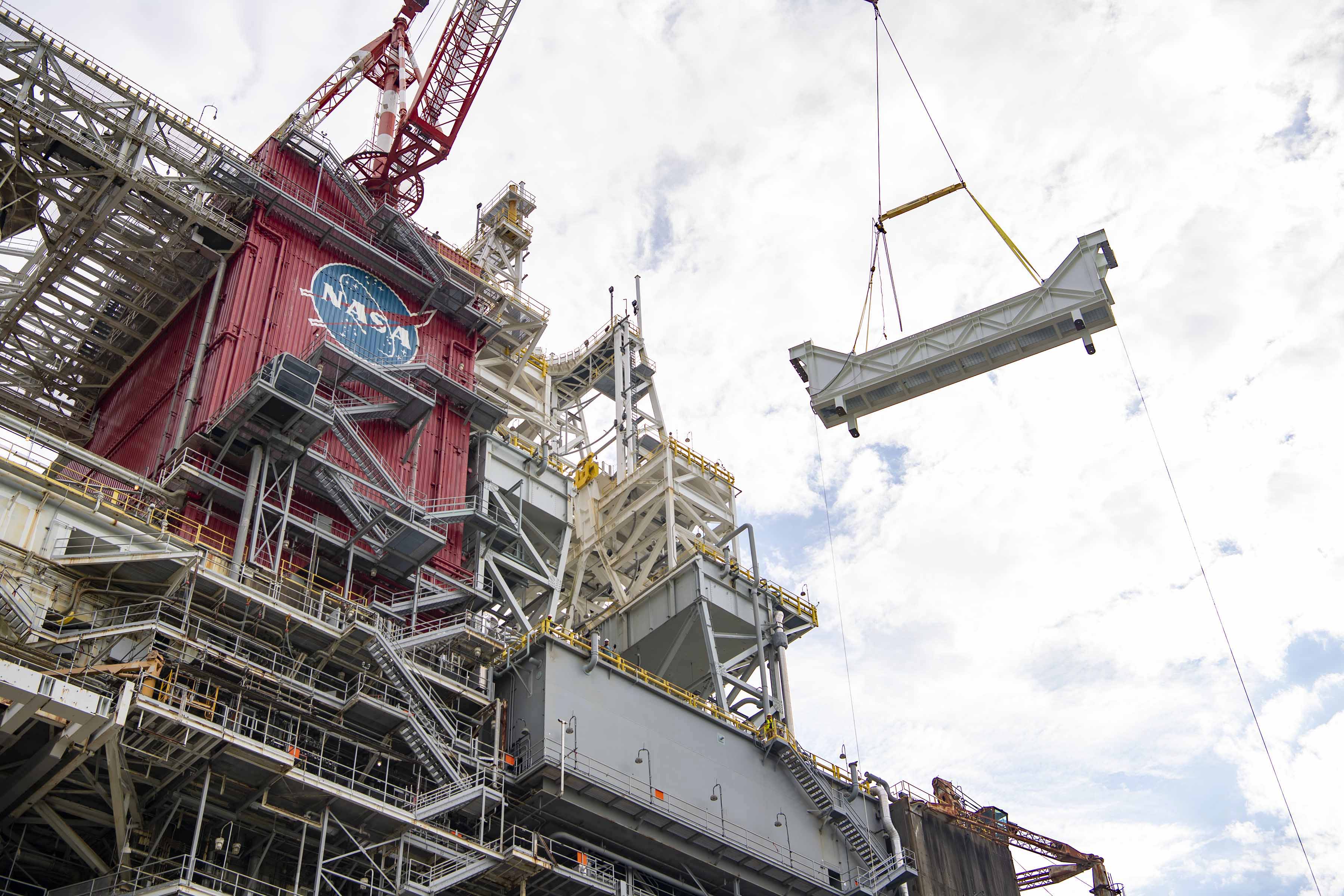 two large trusses suspended and ready for installation onto the Thad Cochran Test Stand