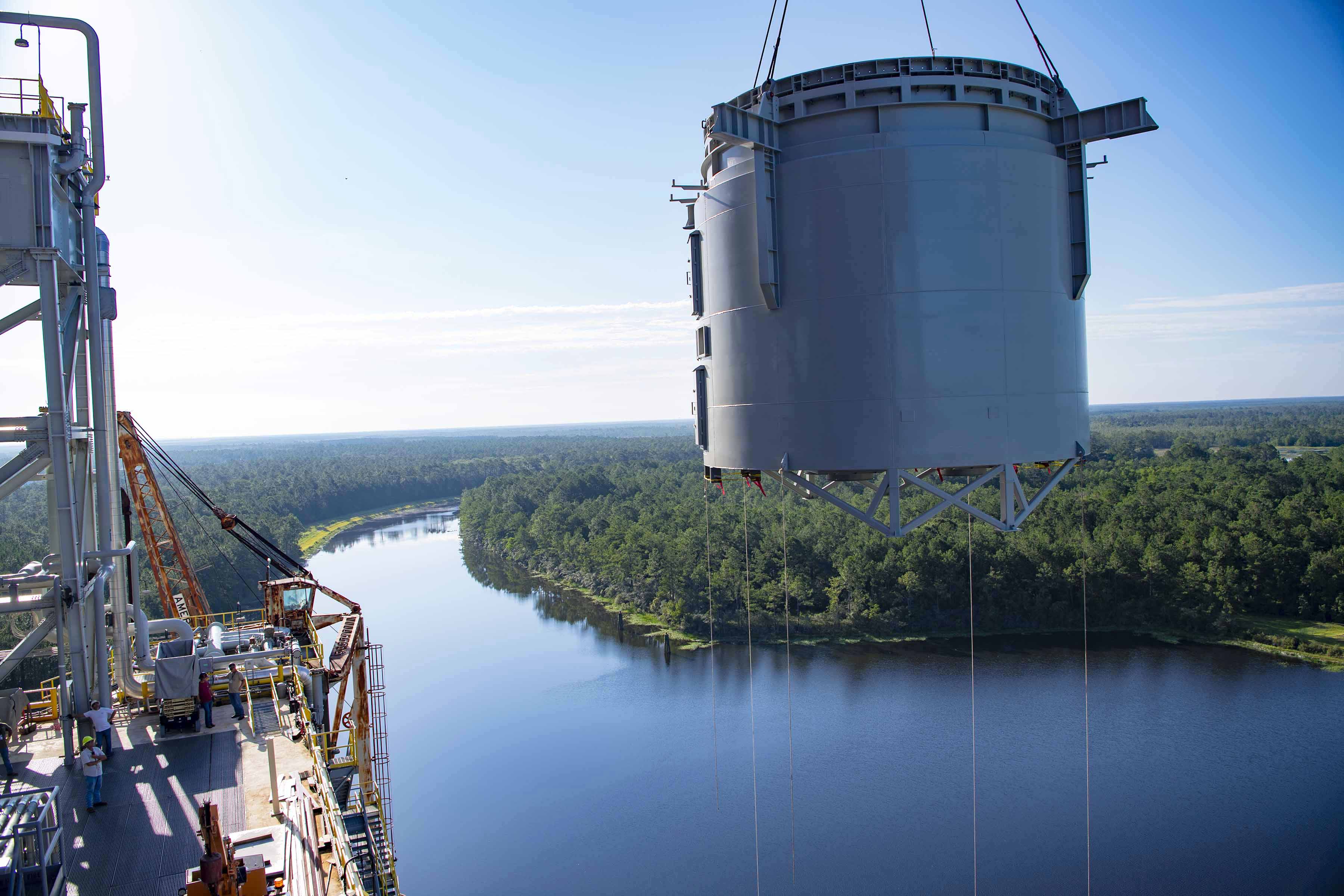 interstage simulator floats high in the sky while being hoisted onto the Thad Cochran Test Stand
