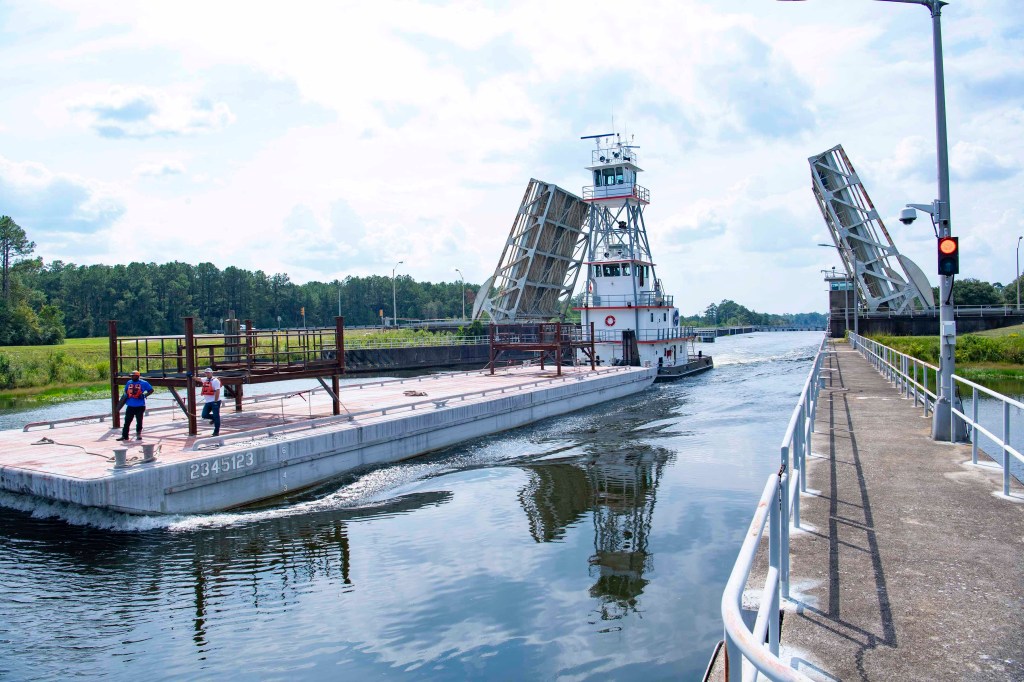 a barge carrying a pair of umbilical support structures