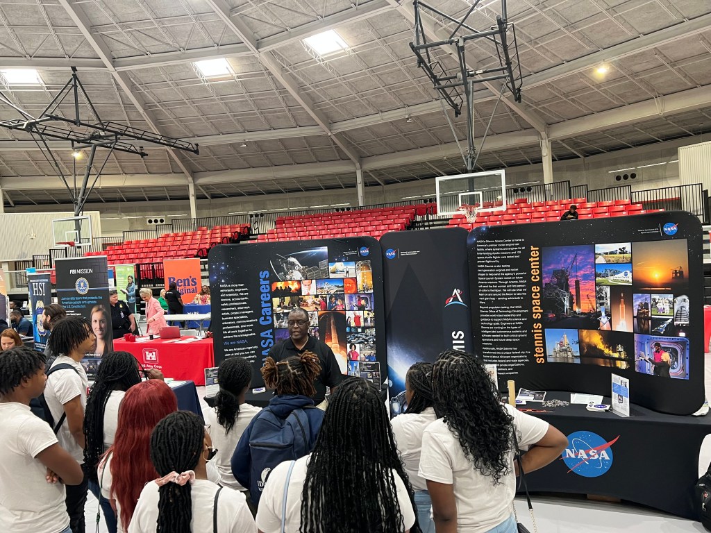 crowd gathers around speaker at career fair