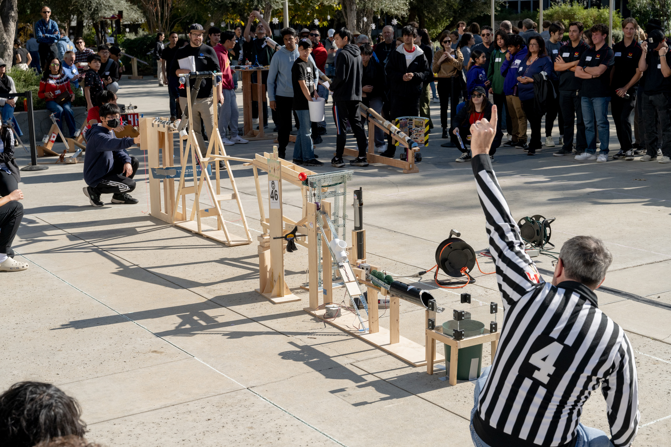 The homemade devices built by competing teams relied on catapults, crossbows, small motors, and more to accomplish seven consecutive steps to sink a crumpled piece of paper into a wastebasket.