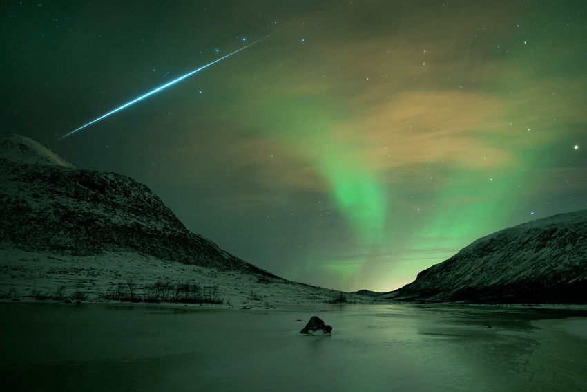 Northern Lights, or aurora borealis, haunted skies over the island of Kvaløya, near Tromsø Norway on Dec. 13. This 30 second-long exposure records their shimmering glow gently lighting the wintery coastal scene. A study in contrasts, it also captures the sudden flash of a fireball meteor from December’s excellent Geminid meteor shower. Streaking past familiar stars in the handle of the Big Dipper, the trail points back toward the constellation Gemini, off the top of the view.