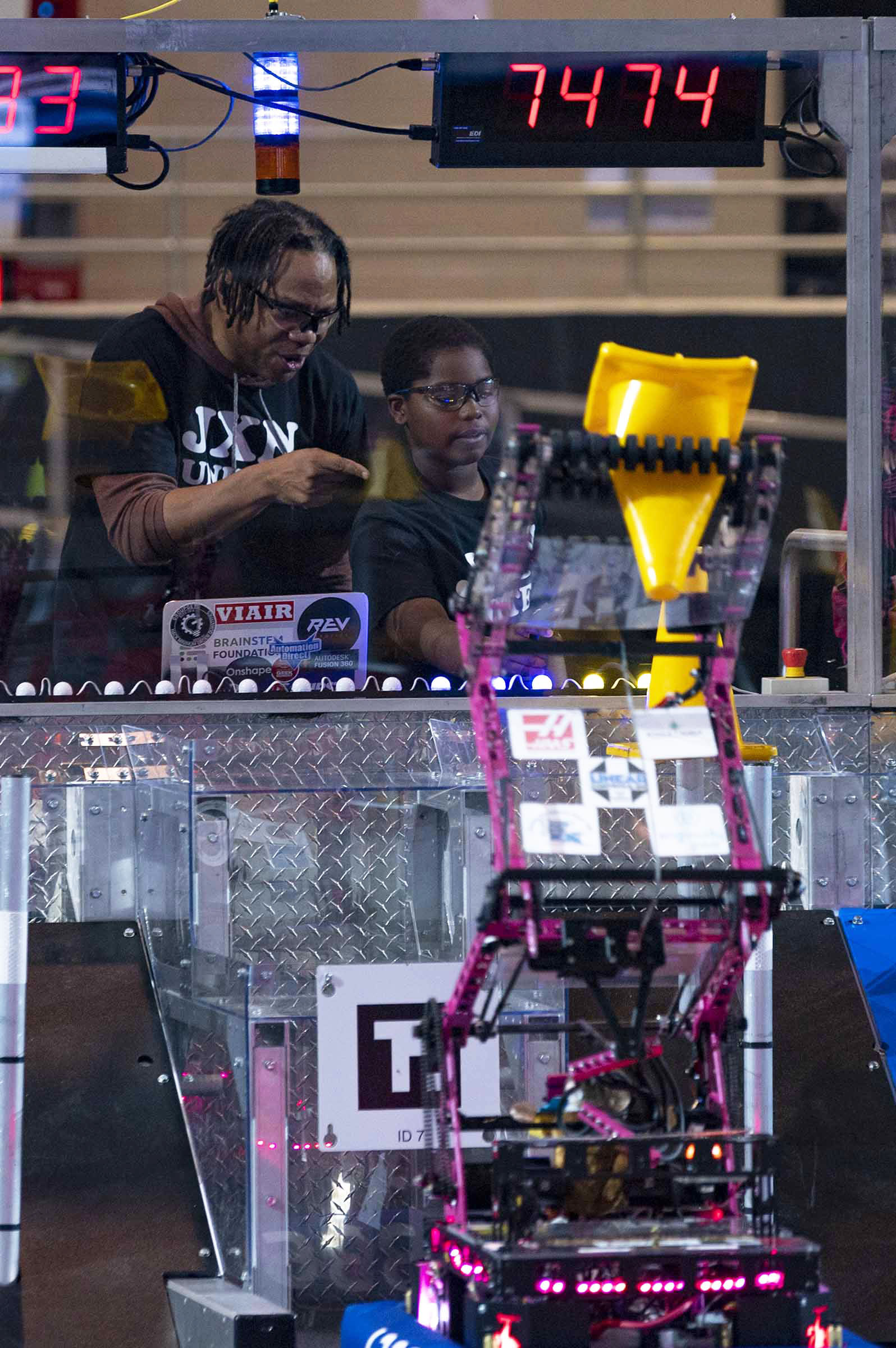 young male child operates robot during a robotics competition held in Laurel, Mississippi.