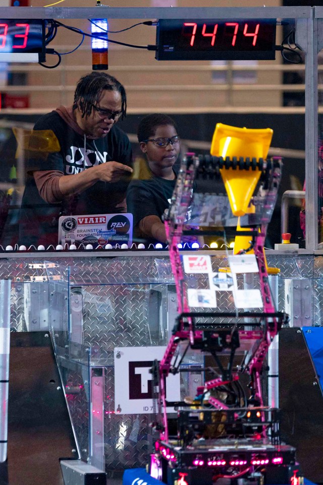 young male child operates robot during a robotics competition held in Laurel, Mississippi.