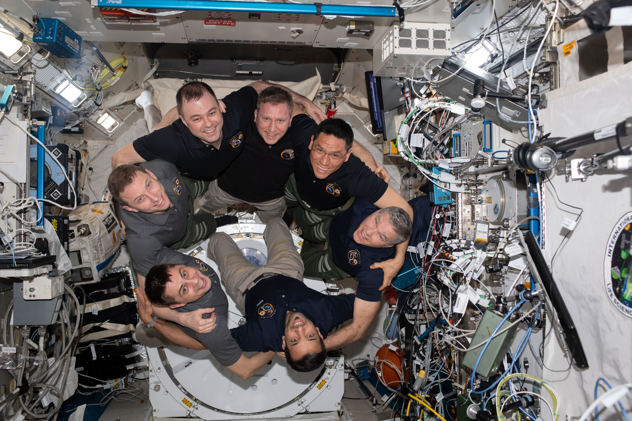 The crew of Expedition circle around for a group photo.