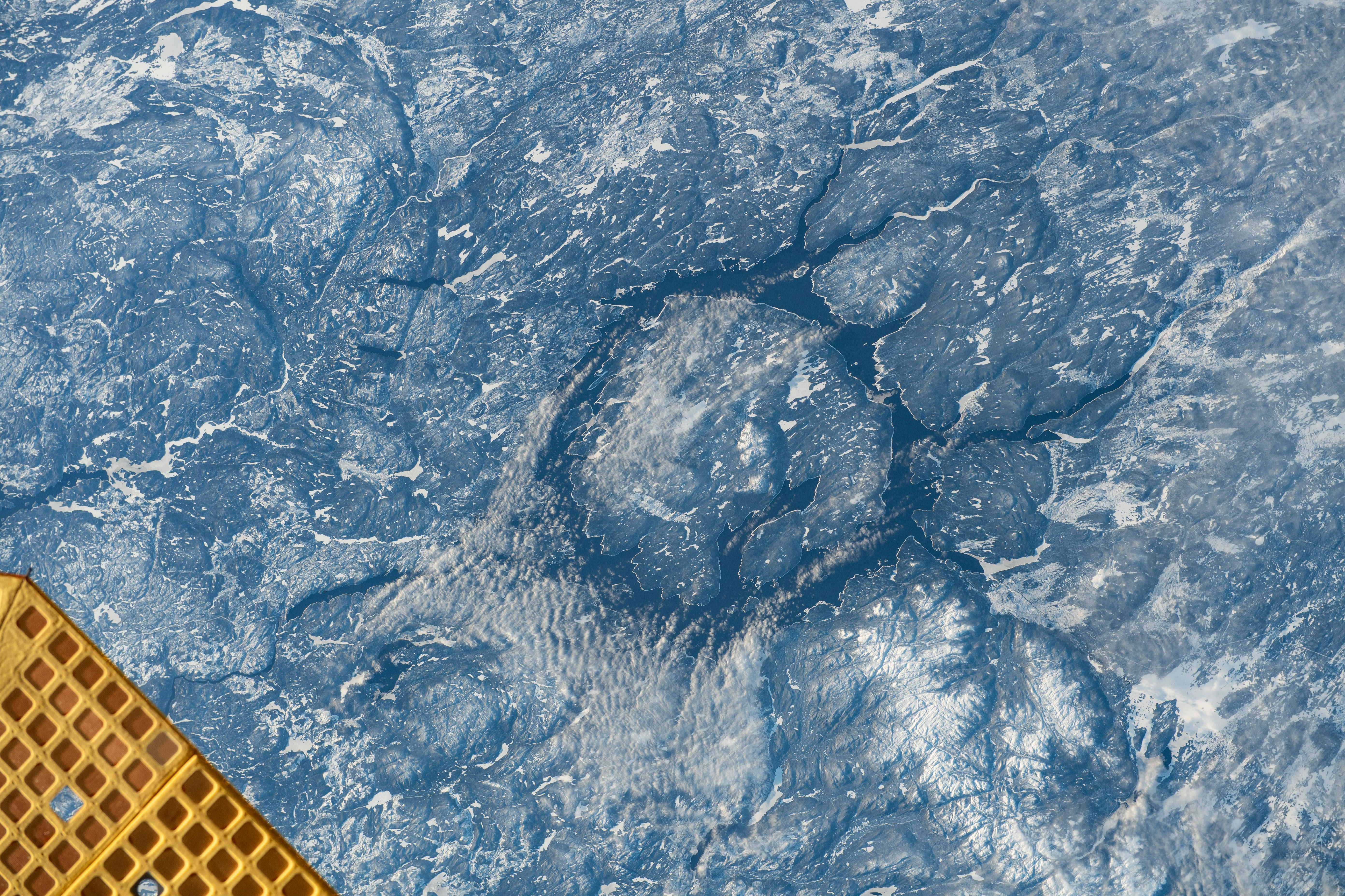 iss070e036696 (Dec. 5, 2023) -- In the center of the ring-shaped Lake Manicouagan lies René-Levasseur Island, formed by a crater that impacted what is now Canada 214 million years ago. Sometimes called the "Eye of Québec," the lake circles roughly 750-square-miles (1,940-square-kiliometers) around. As the International Space Station soared 262 miles above Québec, this image was taken.