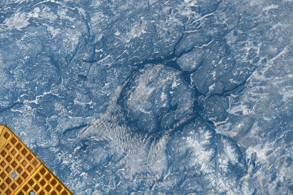iss070e036696 (Dec. 5, 2023) -- In the center of the ring-shaped Lake Manicouagan lies René-Levasseur Island, formed by a crater that impacted what is now Canada 214 million years ago. Sometimes called the "Eye of Québec," the lake circles roughly 750-square-miles (1,940-square-kiliometers) around. As the International Space Station soared 262 miles above Québec, this image was taken.