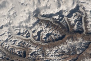 iss070e035652 (Dec. 2, 2023) -- Snow drifts through the Karakoram mountain range as low-hanging clouds blend into the snow-capped summits of mountains as the International Space Station soared 259 miles above Pakistan.