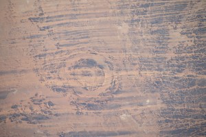 iss070e045218 (Dec. 23, 2023) -- Located in the Sahara Desert, the Aorounga Impact Crater stretches nearly 8 miles (~12.6km) in diameter. The crater is thought to be approximately 325-370 million years old, with outer and inner rings that rise about 330 feet (100 meters) above the surrounding terrain. As the International Space Station soared 258 miles above north-central Chad, this image was taken.