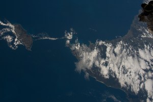 iss070e045876 (Dec. 23, 2023) -- Scattered clouds cover the North Eastern tip of Tasmania (to the right), home to dense forests and grasslands. The Bass Strait separates the island state from King Island (to the left), the second-largest in the strait. As the International Space Station soared 266 miles above, this image was taken.