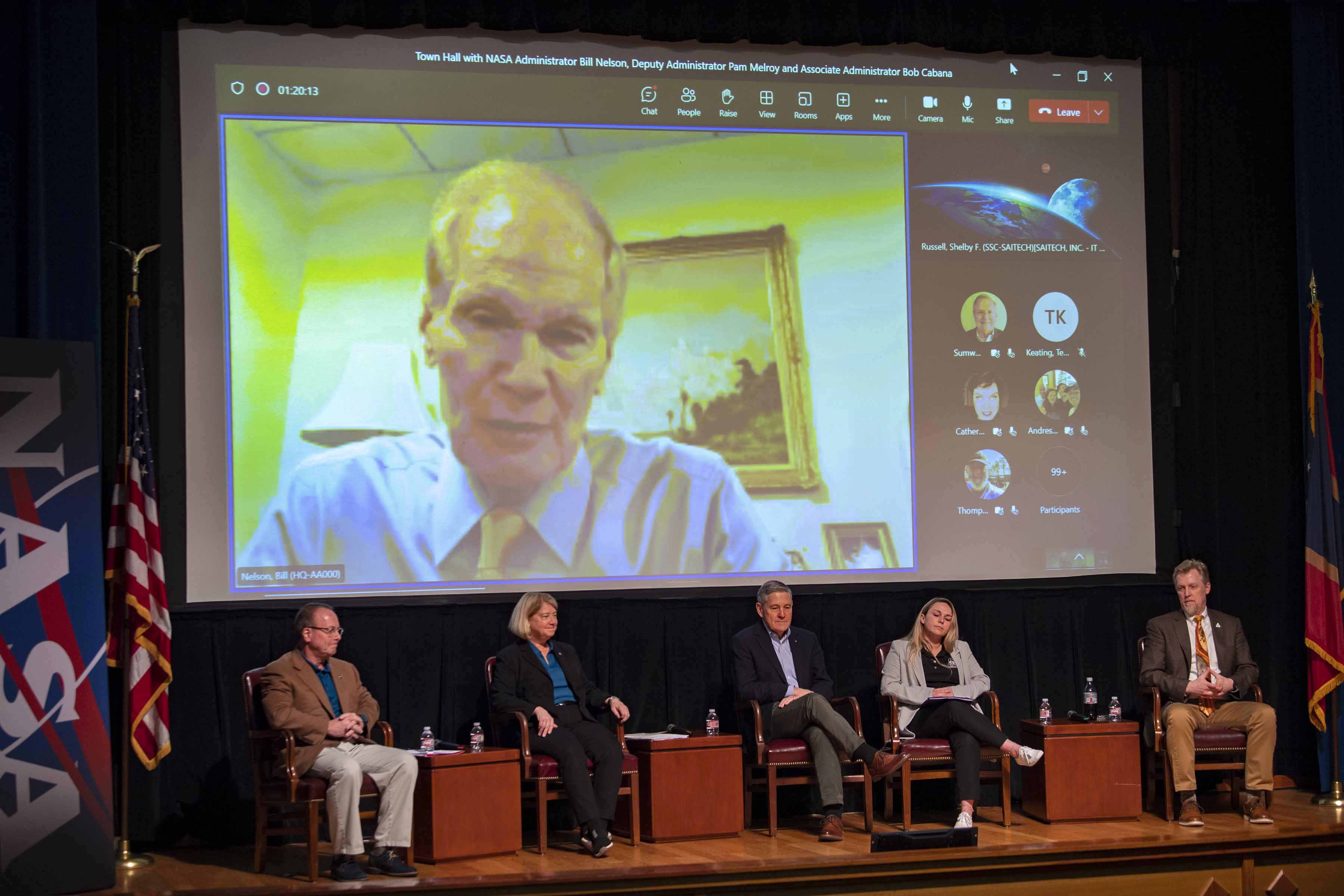 panelists on stage for a town hall meeting