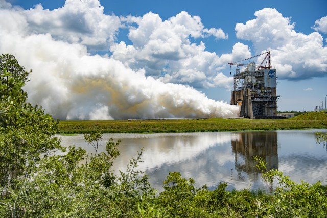 vapor clouds rise into sky as an RS-25 engine test roars