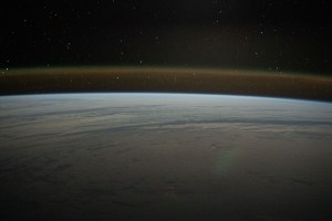 This tranquil orbital pass above a cloud-covered Atlantic Ocean reveals Earth's atmospheric glow beneath a starry sky as the International Space Station soared 271 miles above.