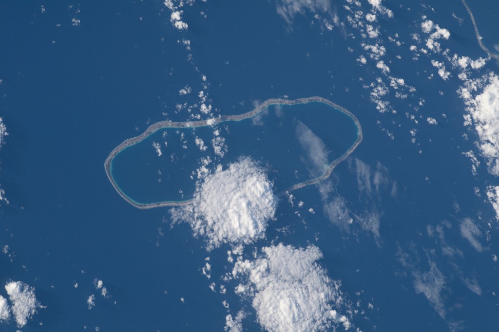 Amanu, a ring-shaped island—or an atoll—is roughly 560 miles (900 kilometers) from Tahiti. Only 10 miles (~15 kilometers) of its land is above water, creating a lagoon in its center. The International Space Station soared 261 miles above the Pacific Ocean as this image was taken.