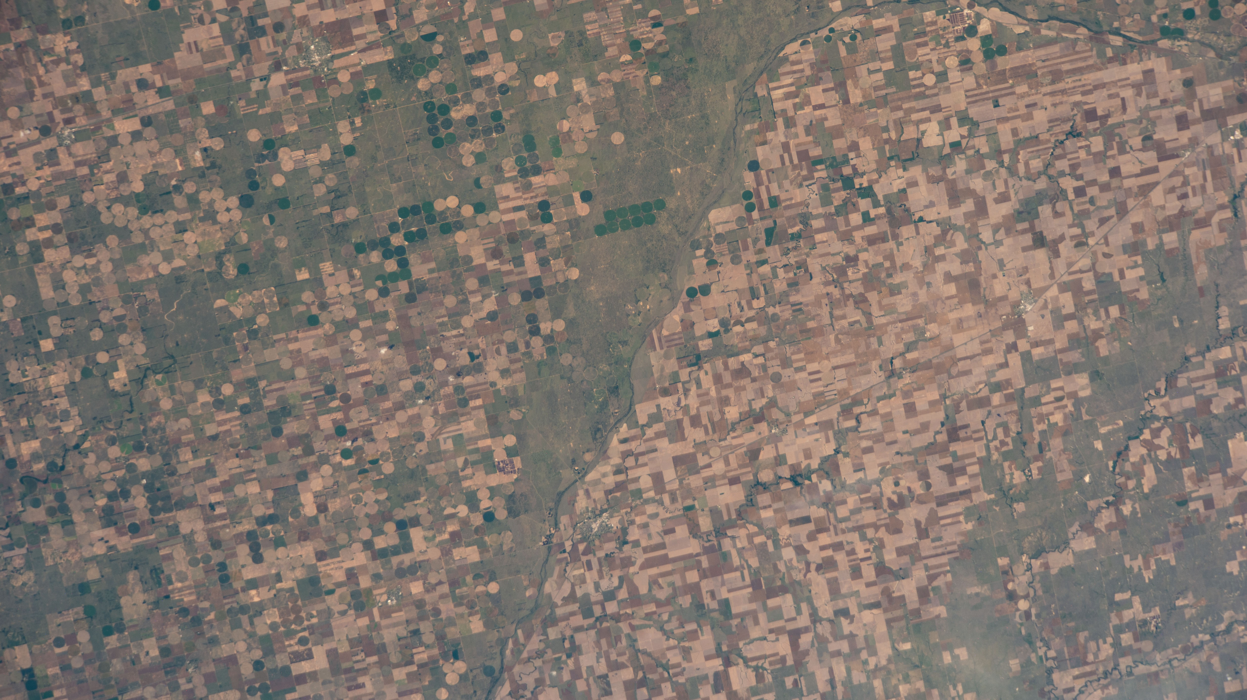 Agricultural activities along the Arkansas River in the state of Kansas, a leader in wheat, grain sorghum and beef production, are pictured from the International Space Station as it orbited 263 miles above the state of Oklahoma.