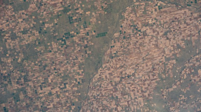 Agricultural activities along the Arkansas River in the state of Kansas, a leader in wheat, grain sorghum and beef production, are pictured from the International Space Station as it orbited 263 miles above the state of Oklahoma.
