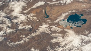 An icy Qinghai Lake (right) and Longyang Gorge Reservoir (top center) in southern China are pictured in this photograph from an external high definition camera on the International Space Station as it orbited 263 miles above.
