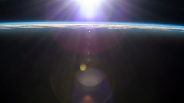 The International Space Station flies into an orbital sunrise 261 miles above the Atlantic Ocean off the coast of northwestern Spain.