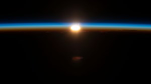 An orbital sunrise begins to illuminate Earth's atmosphere in this photograph from the International Space Station as it orbited 270 miles above the south Pacific Ocean about 2,200 miles west of New Zealand.