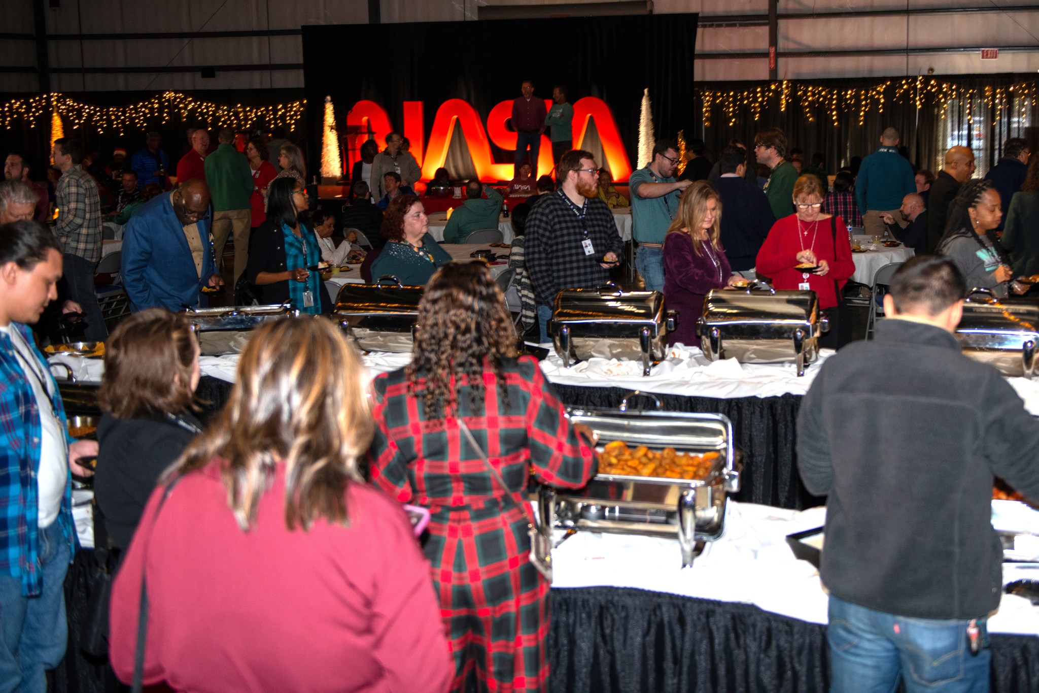 Hundreds of Marshall team members enjoy the buffet-style food offerings at the center’s holiday reception.