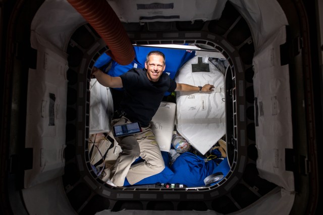 NASA astronaut and Expedition 67 Flight Engineer Bob Hines is pictured during cargo operations and inventory tasks inside the Cygnus space freighter from Northrop Grumman.