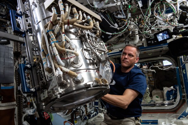 NASA astronaut and Expedition 67 Flight Engineer Bob Hines works to remove and replace the Material Science Laboratory's vacuum sensor inside the International Space Station's U.S. Destiny laboratory module.