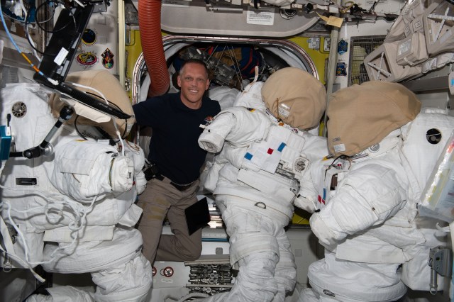 Expedition 67 Flight Engineer and NASA astronaut Bob Hines works on U.S. spacesuits inside the International Space Station's Quest airlock.