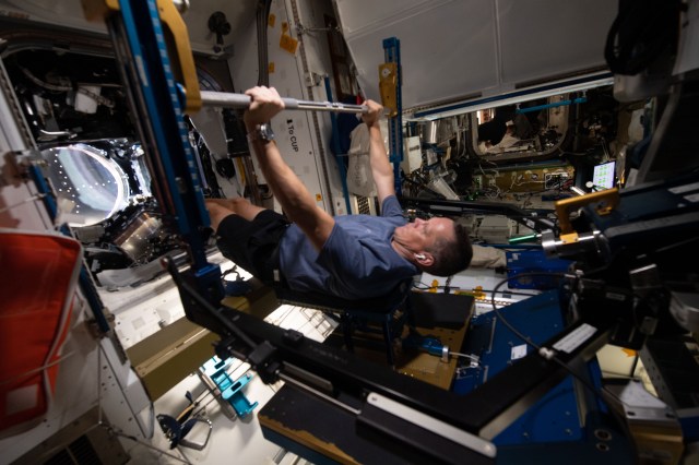 NASA astronaut and Expedition 67 Flight Engineer Bob Hines works out on the Advanced Resistive Exercise Device (ARED) inside the International Space Station's Tranquility module. The ARED mimics the inertial forces generated when lifting free weights on Earth enabling crew members to experience load and maintain muscle strength and mass during a long-term space mission.