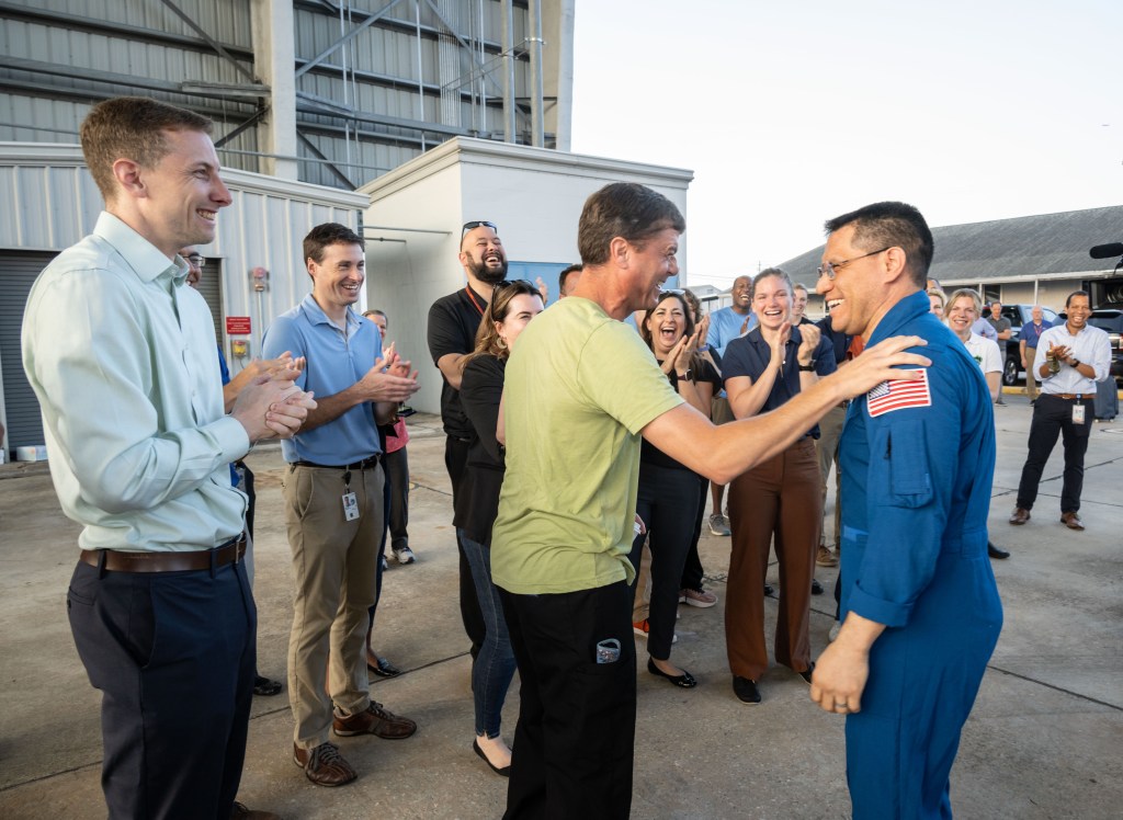 NASA astronaut Frank Rubio is greeted by coworkers, including fellow NASA astronauts Woody Hoburg (far left) and Reid Wiseman (center), following his arrival at Ellington Field in Houston, Texas, aboard a NASA jet. Rubio had just completed a 371-day mission aboard the International Space Station the day before.