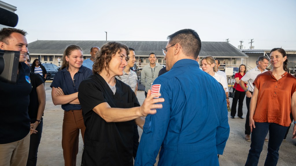 NASA astronaut Frank Rubio is greeted by coworkers, including fellow NASA astronaut Christina Koch (center), following his arrival at Ellington Field in Houston, Texas, aboard a NASA jet. Rubio had just completed a 371-day mission aboard the International Space Station the day before.
