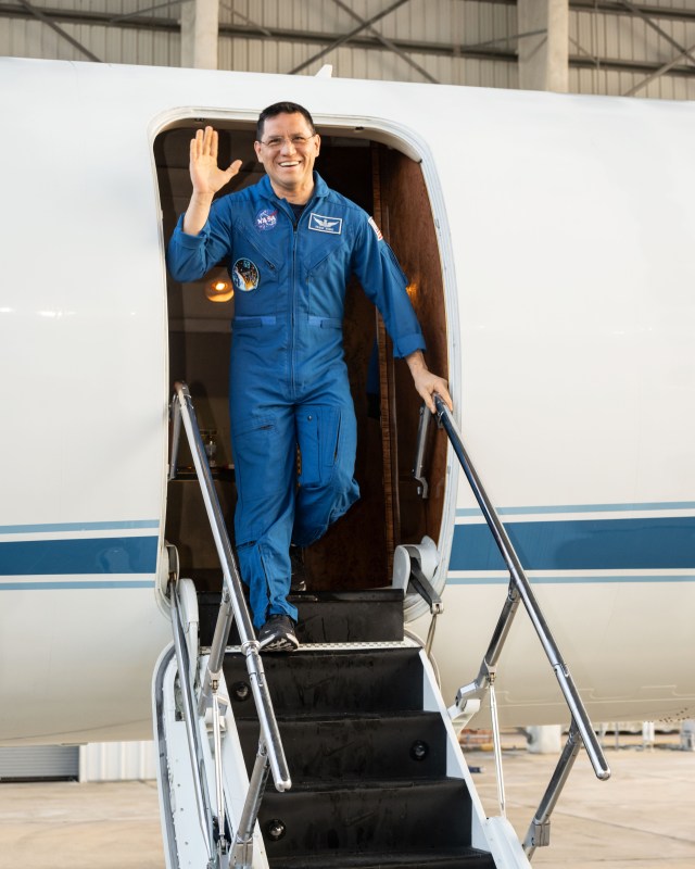 NASA astronaut Frank Rubio waves after returning to Ellington Field in Houston, Texas, aboard a NASA jet following the completion of his 371-day mission aboard the International Space Station.