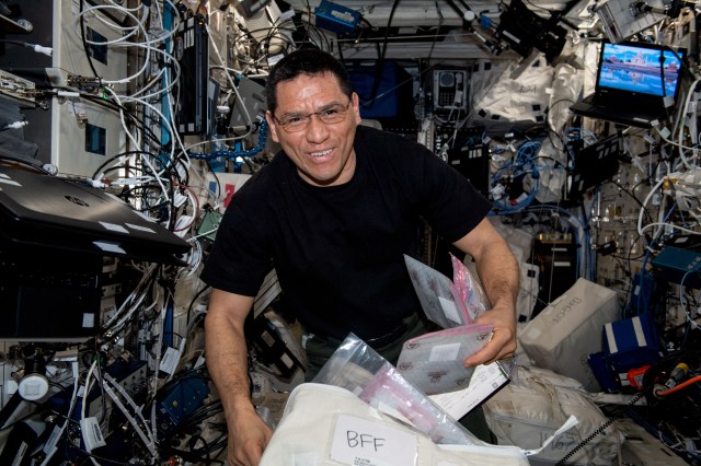 NASA astronaut and Expedition 69 Flight Engineer Frank Rubio unpacks gear he will use to replace and install components inside the BioFabrication Facility, a research device designed to print organ-like tissues in microgravity and learn how to manufacture whole, fully-functioning human organs in space.