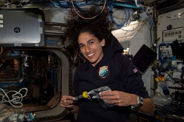iss069e085932_alt (Sept. 4, 2023) --- NASA astronaut and Expedition 69 Flight Engineer Jasmin Moghbeli collects water samples for microbial analysis inside the International Space Station's Destiny laboratory module.