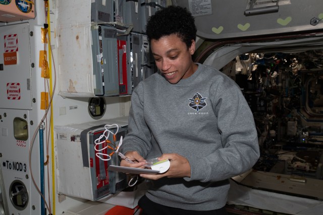 NASA astronaut and Expedition 67 Flight Engineer Jessica Watkins checks out gifts she received for her 34th birthday aboard the International Space Station.