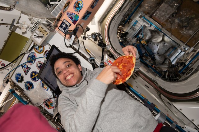 NASA astronaut and Expedition 67 Flight Engineer Jessica Watkins enjoys a personal size pizza during dinner time aboard the International Space Station.